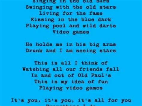Video games He holds me in his big arms He's drunk and I am seeing stars This is all I think of Watching all our friends fall Leaning out of old cars This is my idea of fun Playing …
